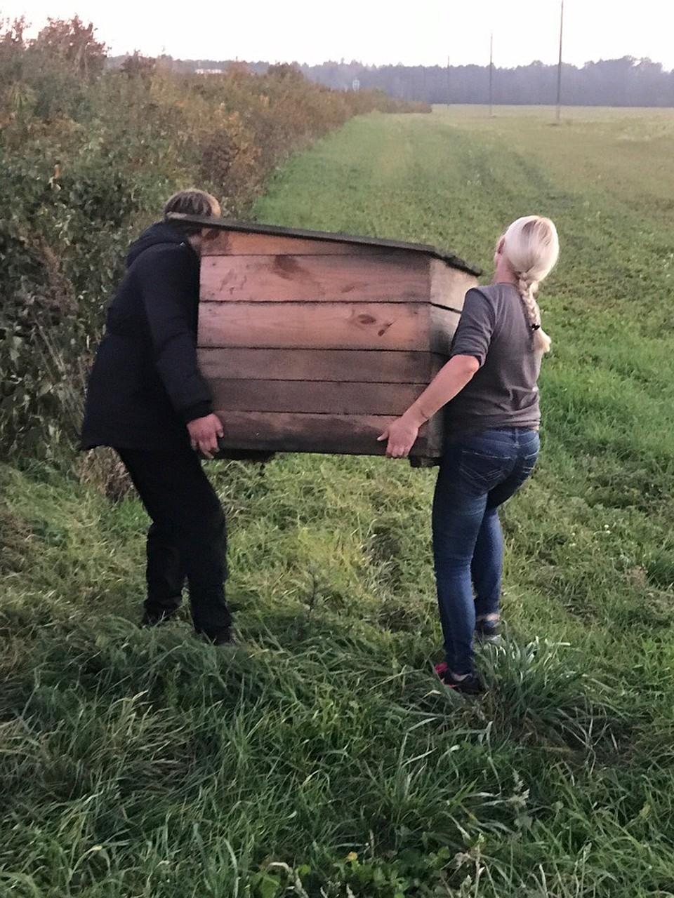 Яна с папой привезли на поле будку, чтобы щенкам и их маме было где укрыться от дождя. Фото: личный архив Яны
